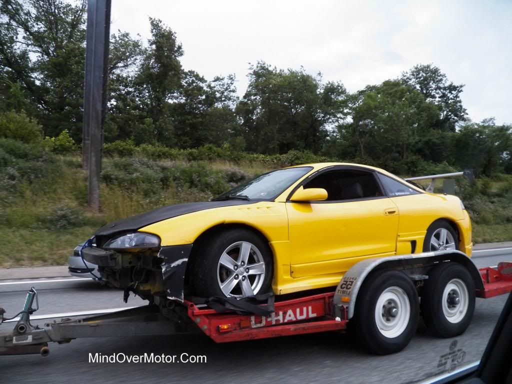 2nd Generation Mitsubishi Eclipse with bumper damage, Front Angle on a Trailer